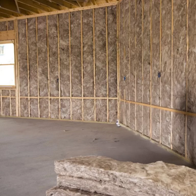 Insulation installed between open wall studs in an unfinished residential space