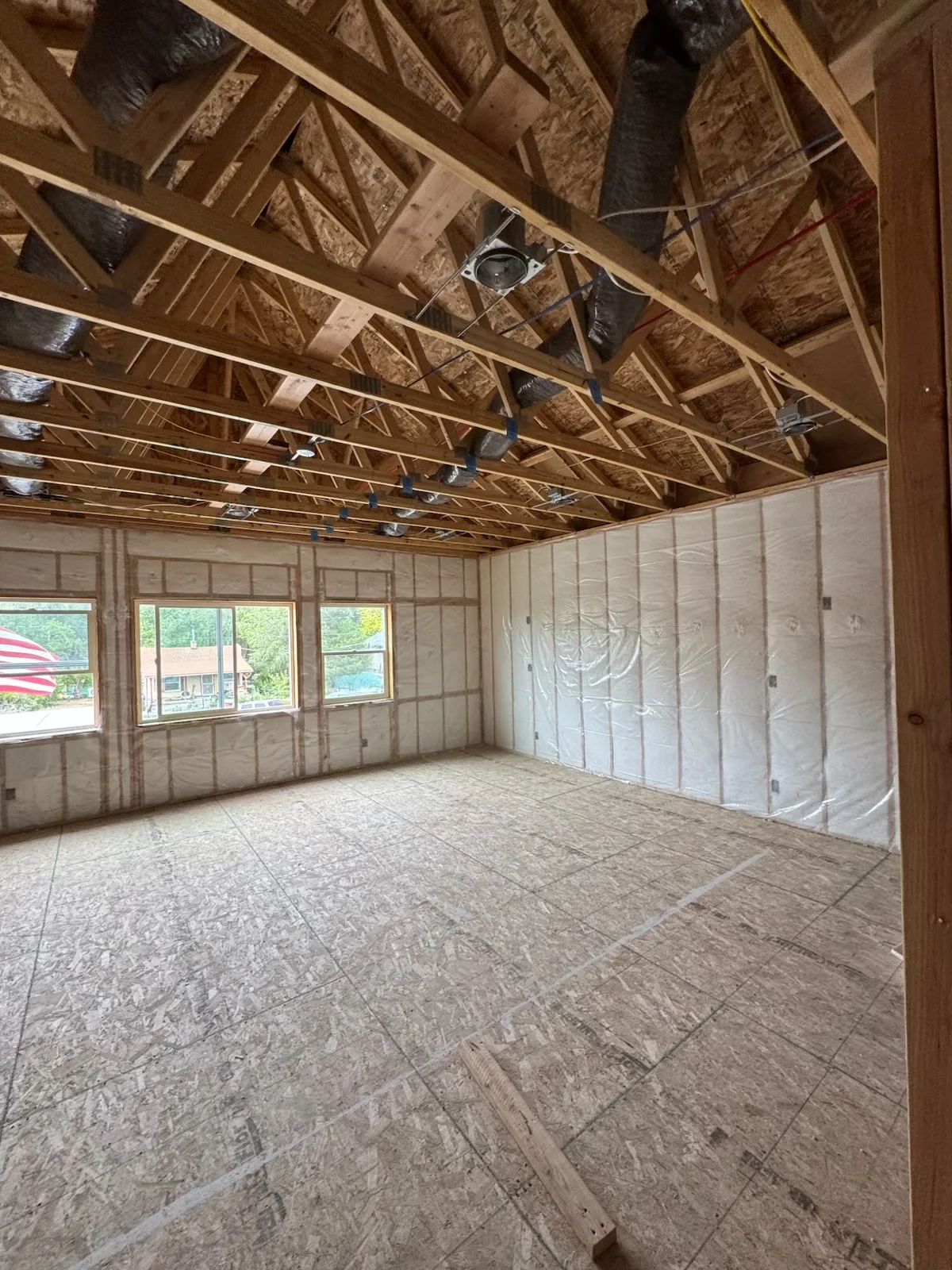 Open-framed new-construction room with insulation installed in exterior walls
