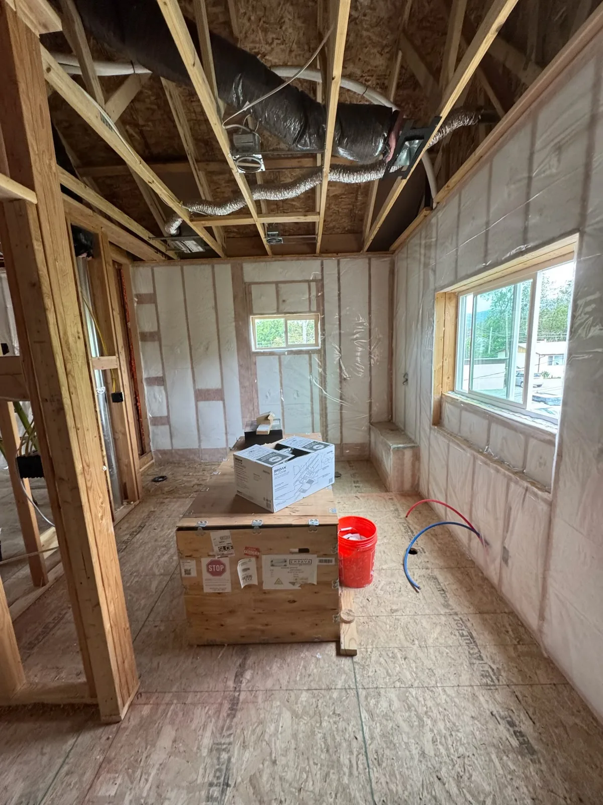New-construction corridor with insulation fitted between exterior wall studs