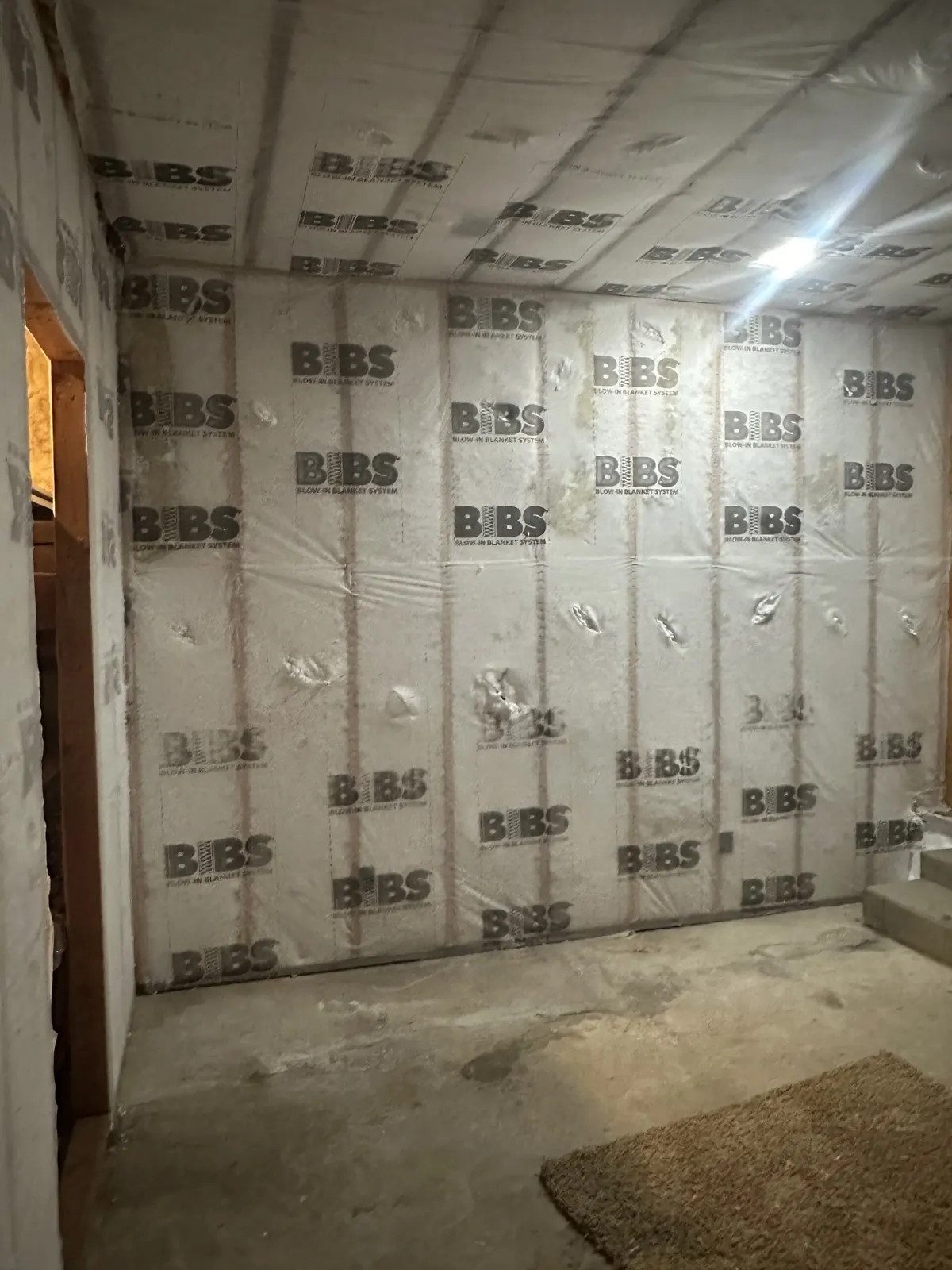 Netted-and-blown insulation installed in open wall framing