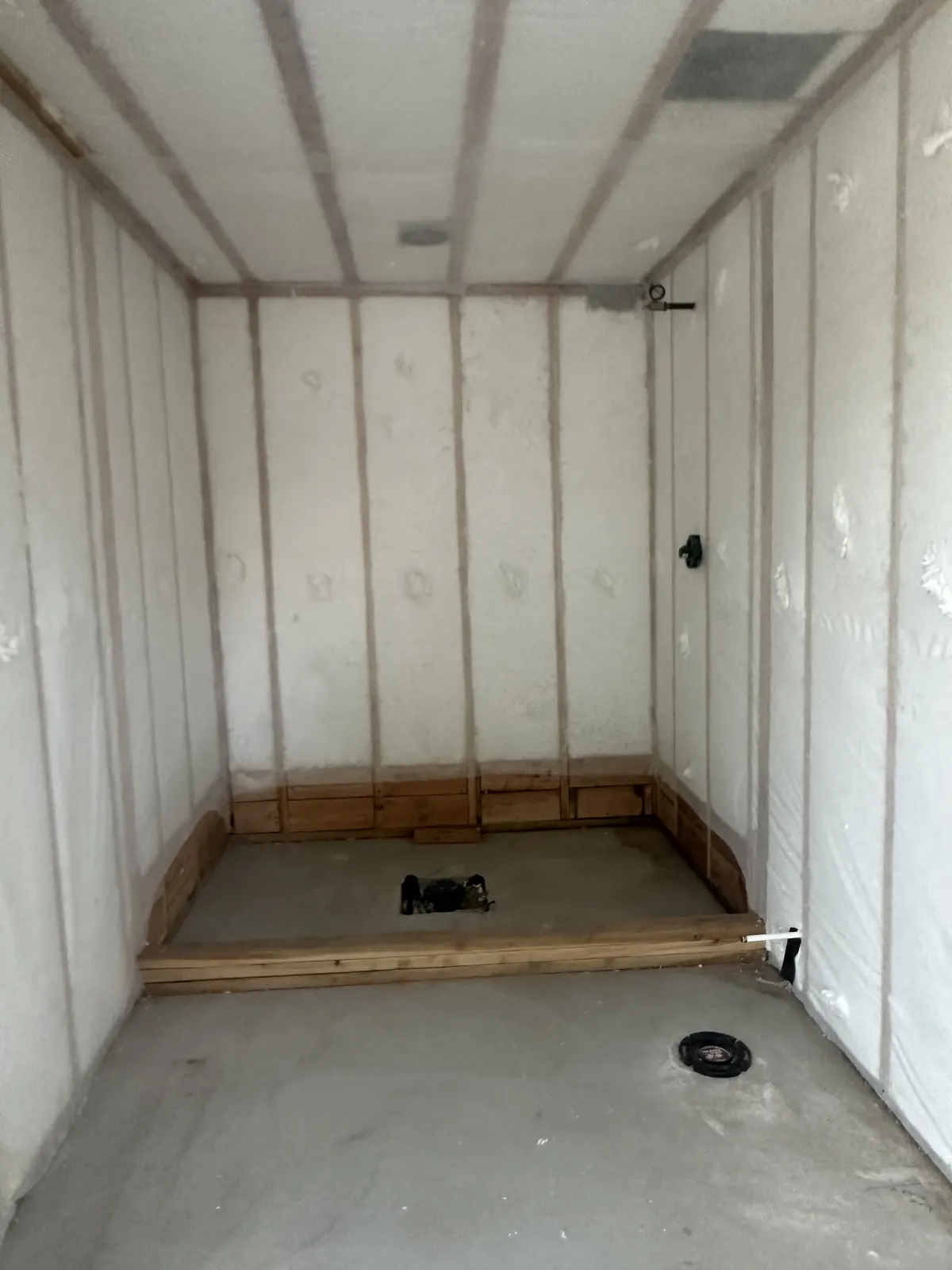 Insulated curved wall inside a circular storage-bin conversion