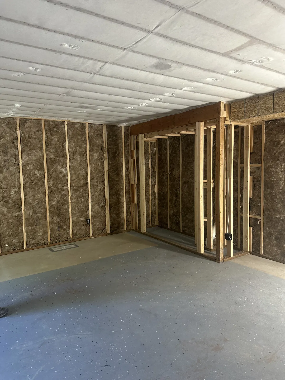 Netted ceiling and insulated walls in an open-framed residential space