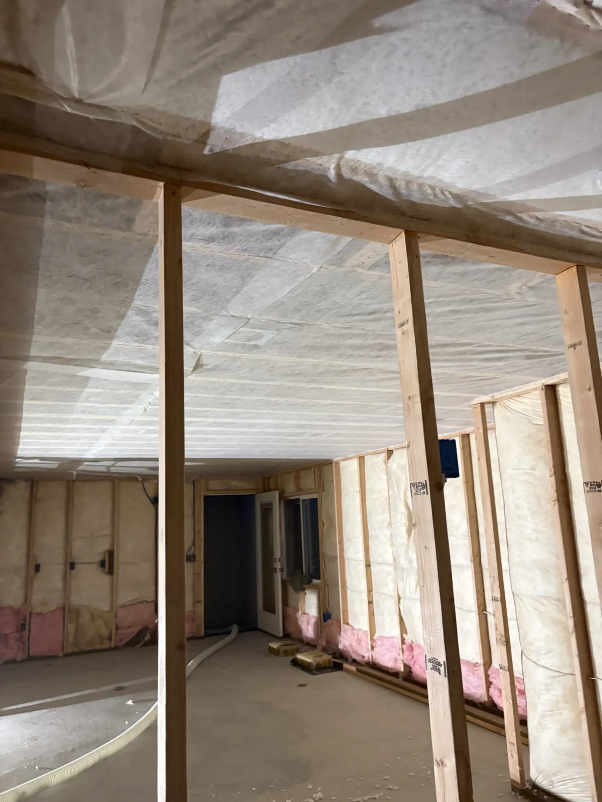 Netted-and-blown insulation installed across an open residential ceiling
